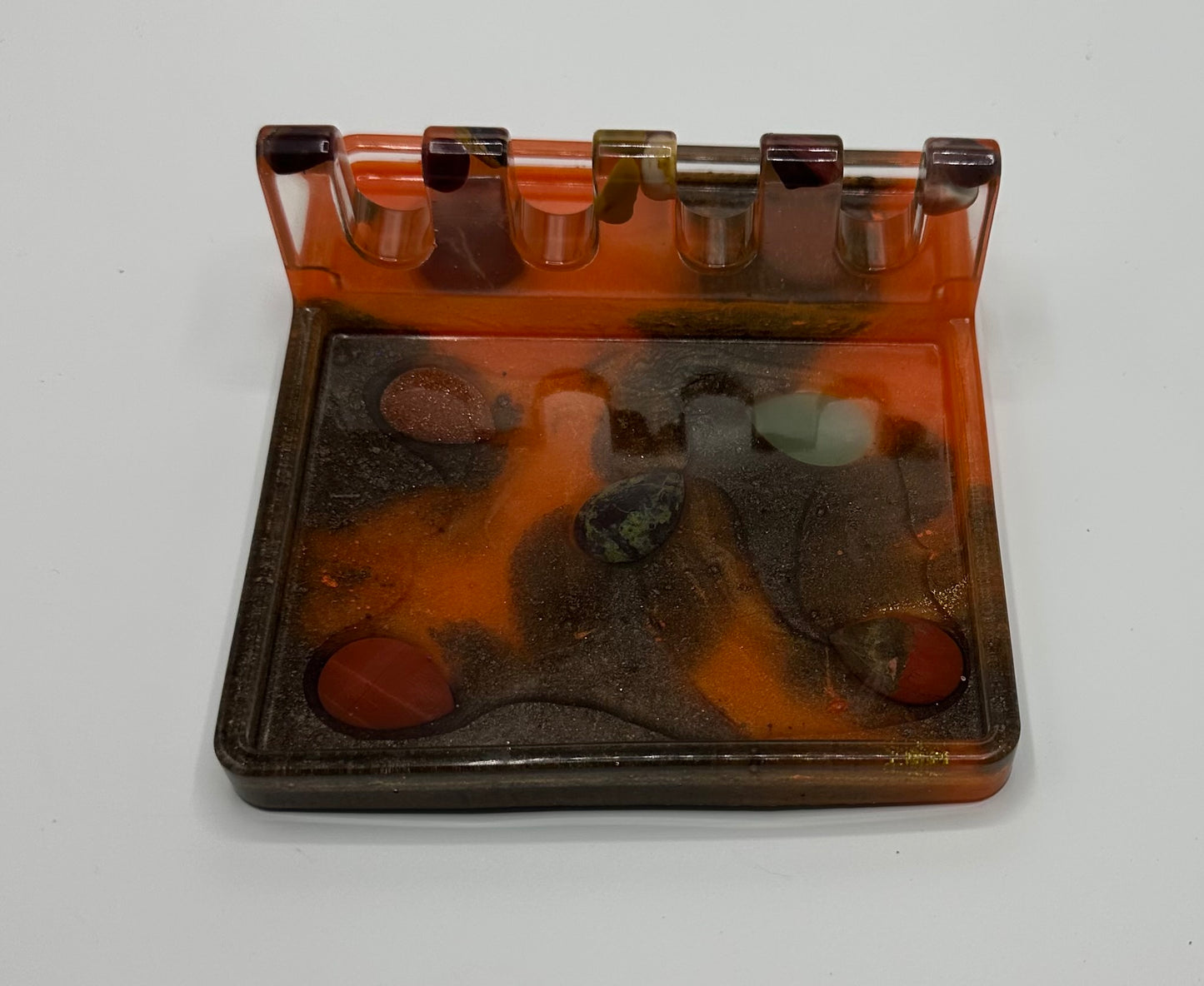 Orange and black resin spoon rest with inlaid natural stone