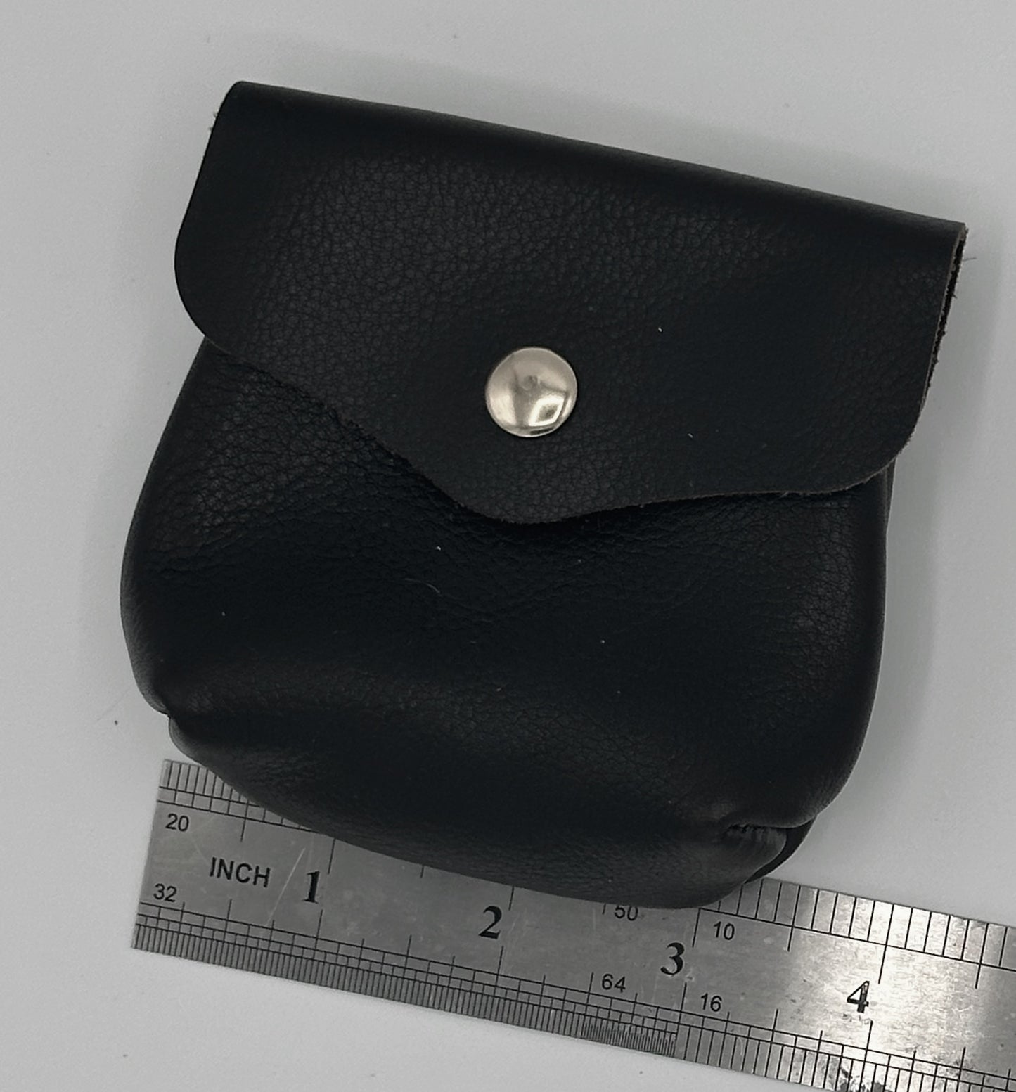 Dark brown leather pouch with skull rivets