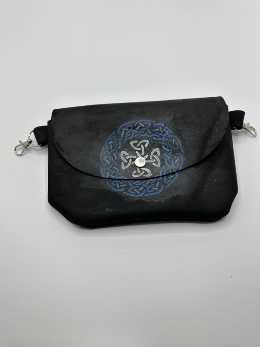 Black leather bag with blue, green, and silver painting